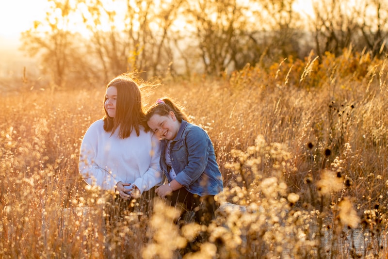 Loving mother and daughter share tender moment in golden prairie grass, Madison Wisconsin family photography