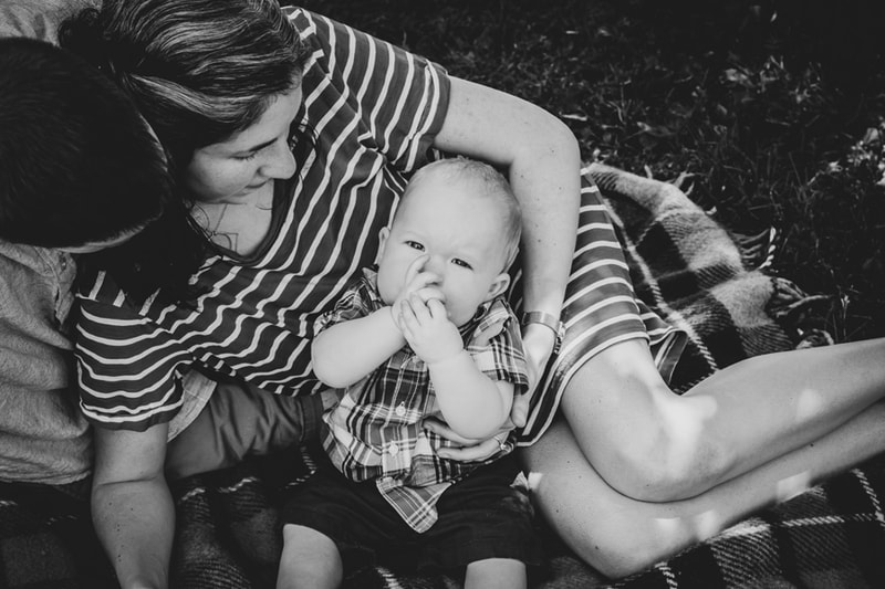 Mother and baby sharing tender moment during outdoor family portrait session in Madison, Wisconsin