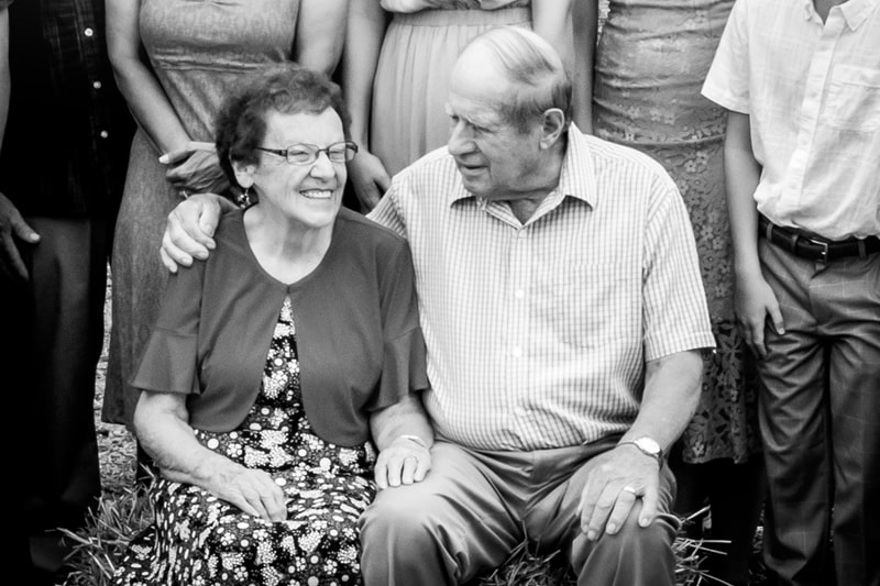Loving elderly couple shares tender moment during family portrait session in Madison, Wisconsin