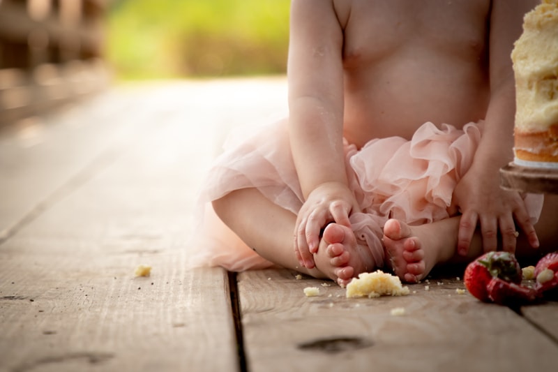 Baby's tiny feet and hands during cake smash milestone photography session in Madison, Wisconsin